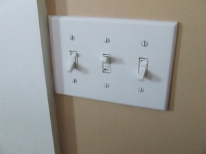 Light switch cover plate with dimmer switch.